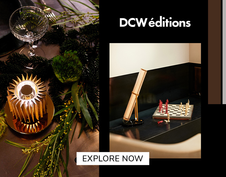 Elegant DCW éditions lighting displayed on a festive table and beside a chessboard, featuring modern sculptural lamps in warm tones with text ‘Explore Now’.